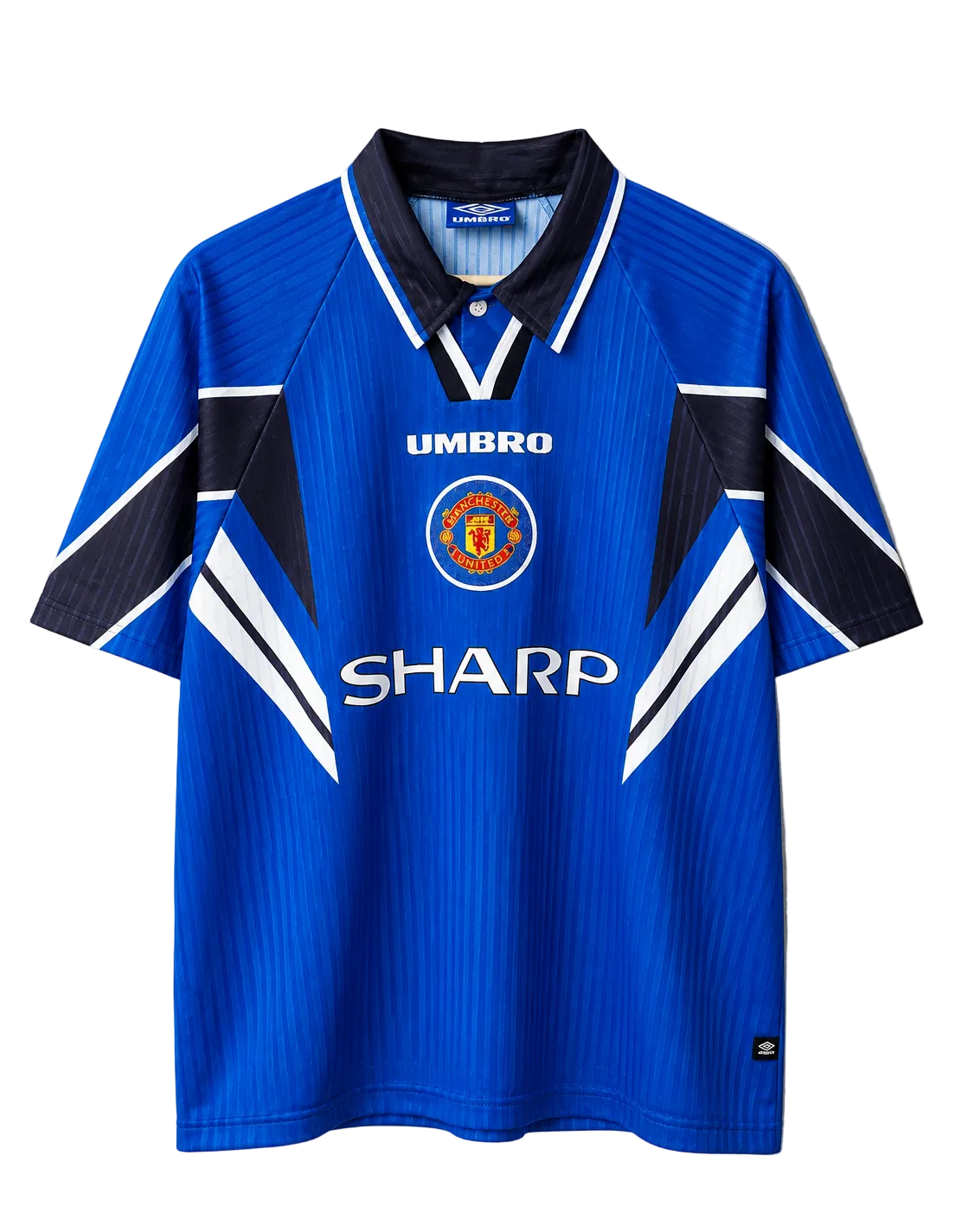 A vintage blue Manchester United short-sleeve polo jersey by Umbro, featuring the 'SHARP' sponsor logo on the front, the Manchester United crest, and navy and white geometric accents on the shoulders and sides, displayed flat against a neutral gray background.