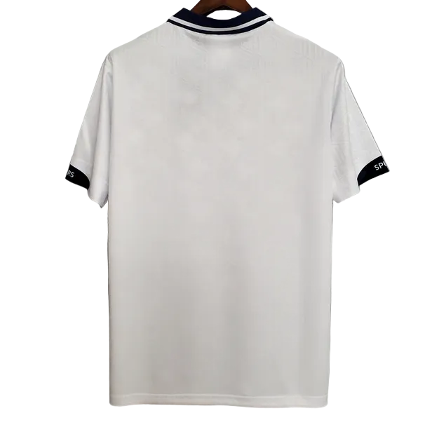 White polo shirt with black trim on a gray background