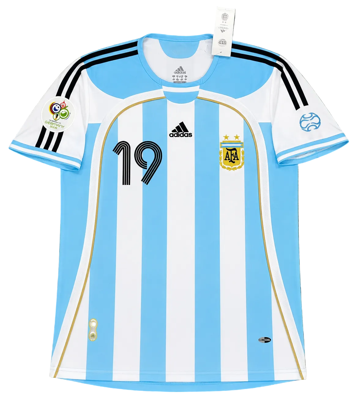 An Argentina national football team home jersey by Adidas, featuring light blue and white vertical stripes with black shoulder stripes, the number 19 on the chest, and the AFA crest, laid flat on a green grass background.
